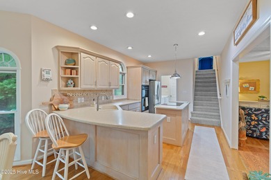 This beautiful home, across from a pretty pond, is located along on Lockwood Folly Country Club in North Carolina - for sale on GolfHomes.com, golf home, golf lot