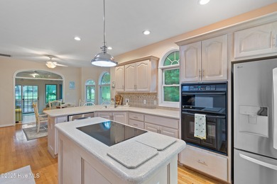 This beautiful home, across from a pretty pond, is located along on Lockwood Folly Country Club in North Carolina - for sale on GolfHomes.com, golf home, golf lot