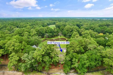 This beautiful home, across from a pretty pond, is located along on Lockwood Folly Country Club in North Carolina - for sale on GolfHomes.com, golf home, golf lot