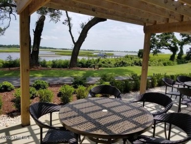 This beautiful home, across from a pretty pond, is located along on Lockwood Folly Country Club in North Carolina - for sale on GolfHomes.com, golf home, golf lot