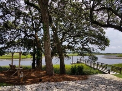 This beautiful home, across from a pretty pond, is located along on Lockwood Folly Country Club in North Carolina - for sale on GolfHomes.com, golf home, golf lot