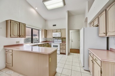 This Camelback model with vaulted ceilings and enclosed patio on Westbrook Village Golf Club in Arizona - for sale on GolfHomes.com, golf home, golf lot