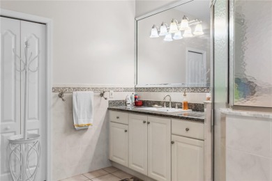 This beautifully designed concrete block stucco home stands out on The Grand Club Cypress Course in Florida - for sale on GolfHomes.com, golf home, golf lot