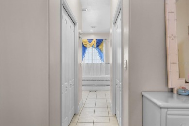 This beautifully designed concrete block stucco home stands out on The Grand Club Cypress Course in Florida - for sale on GolfHomes.com, golf home, golf lot