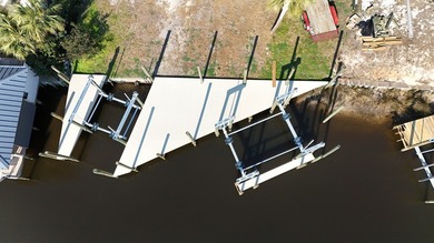 Check out this Canalfront lot with 2 NEWLY BUILT BOAT SLIPS! on  in Florida - for sale on GolfHomes.com, golf home, golf lot