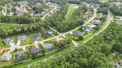 This beautifully designed concrete block stucco home stands out on The Grand Club Cypress Course in Florida - for sale on GolfHomes.com, golf home, golf lot