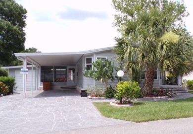 Discover the charm of this beautiful 2-bedroom Palm Harbor home on Schalamar Creek Golf and Country Club in Florida - for sale on GolfHomes.com, golf home, golf lot