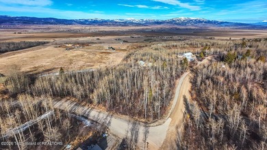 Nestled among mature trees in the heart of Star Valley Ranch on Star Valley RV Golf Course in Wyoming - for sale on GolfHomes.com, golf home, golf lot