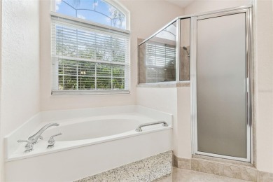 Location, Location - Tampa Palms beauty. This 4/3/2 plus a den on Tampa Palms Golf and Country Club in Florida - for sale on GolfHomes.com, golf home, golf lot