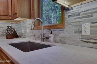 Meticulously maintained log-sided lakefront on TinkWig Lake with on Woodloch Springs Country Club in Pennsylvania - for sale on GolfHomes.com, golf home, golf lot