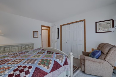 Meticulously maintained log-sided lakefront on TinkWig Lake with on Woodloch Springs Country Club in Pennsylvania - for sale on GolfHomes.com, golf home, golf lot