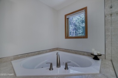 Meticulously maintained log-sided lakefront on TinkWig Lake with on Woodloch Springs Country Club in Pennsylvania - for sale on GolfHomes.com, golf home, golf lot
