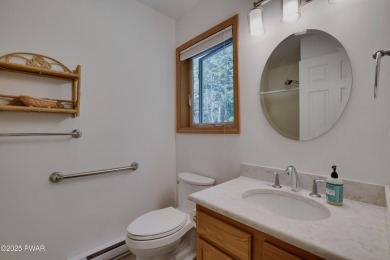 Meticulously maintained log-sided lakefront on TinkWig Lake with on Woodloch Springs Country Club in Pennsylvania - for sale on GolfHomes.com, golf home, golf lot