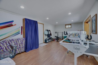Meticulously maintained log-sided lakefront on TinkWig Lake with on Woodloch Springs Country Club in Pennsylvania - for sale on GolfHomes.com, golf home, golf lot