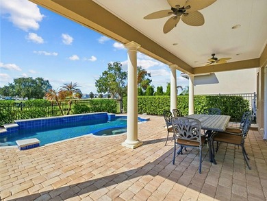 Wake up to golf course views and end your day poolside in this on ChampionsGate Golf Resort in Florida - for sale on GolfHomes.com, golf home, golf lot