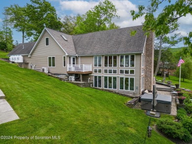 Indulge in the epitome of lakeside living with this exquisite on Scranton Canoe Club in Pennsylvania - for sale on GolfHomes.com, golf home, golf lot