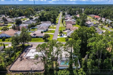 Discover the charm of 57 Woodhollow Dr, a stunning custom-built on The Grand Club - Pine Lakes Course in Florida - for sale on GolfHomes.com, golf home, golf lot