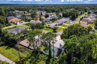 Discover the charm of 57 Woodhollow Dr, a stunning custom-built on The Grand Club - Pine Lakes Course in Florida - for sale on GolfHomes.com, golf home, golf lot