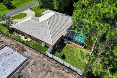 Discover the charm of 57 Woodhollow Dr, a stunning custom-built on The Grand Club - Pine Lakes Course in Florida - for sale on GolfHomes.com, golf home, golf lot