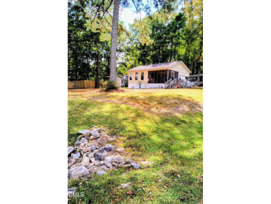 Experience lake life with water views of Lake Royale! This cozy on River Golf and Country Club at Lake Royale in North Carolina - for sale on GolfHomes.com, golf home, golf lot