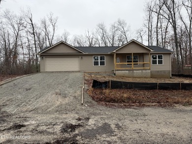 Experience the perfect blend of modern comfort and lakeside on Lake Tansi Village Country Club in Tennessee - for sale on GolfHomes.com, golf home, golf lot