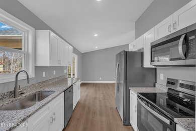 Experience the perfect blend of modern comfort and lakeside on Lake Tansi Village Country Club in Tennessee - for sale on GolfHomes.com, golf home, golf lot