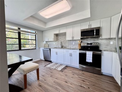 WELCOME to this bright and spacious villa located in the HIGHLY on East Lake Woodlands Country Club in Florida - for sale on GolfHomes.com, golf home, golf lot