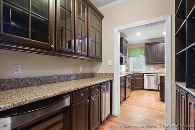 Nestled in a peaceful setting in Gates Four, this beautiful home on Gates Four Golf and Country Club in North Carolina - for sale on GolfHomes.com, golf home, golf lot