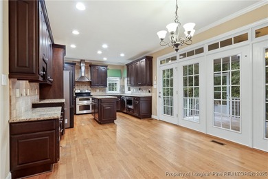 Nestled in a peaceful setting in Gates Four, this beautiful home on Gates Four Golf and Country Club in North Carolina - for sale on GolfHomes.com, golf home, golf lot