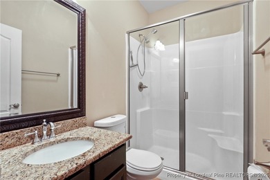 Nestled in a peaceful setting in Gates Four, this beautiful home on Gates Four Golf and Country Club in North Carolina - for sale on GolfHomes.com, golf home, golf lot