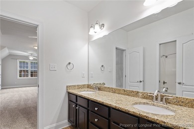 Nestled in a peaceful setting in Gates Four, this beautiful home on Gates Four Golf and Country Club in North Carolina - for sale on GolfHomes.com, golf home, golf lot