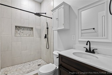 Nestled in a peaceful setting in Gates Four, this beautiful home on Gates Four Golf and Country Club in North Carolina - for sale on GolfHomes.com, golf home, golf lot