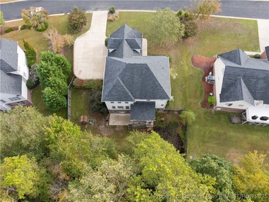 Nestled in a peaceful setting in Gates Four, this beautiful home on Gates Four Golf and Country Club in North Carolina - for sale on GolfHomes.com, golf home, golf lot