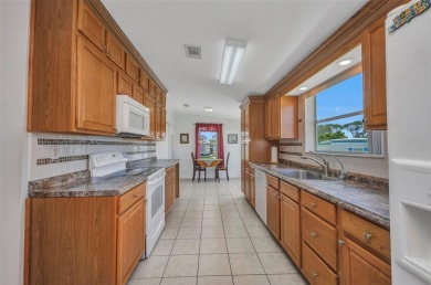 Welcome to 5748 Holiday Park Blvd.  This home is located in the on Sabal Trace Golf and Country Club in Florida - for sale on GolfHomes.com, golf home, golf lot