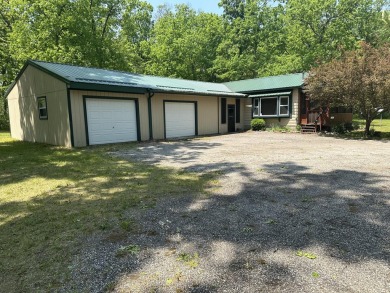 This well kept 2 bedroom is in a great location with paved road on Marquette Trails Country Club in Michigan - for sale on GolfHomes.com, golf home, golf lot
