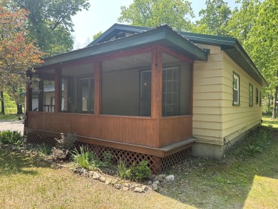 This well kept 2 bedroom is in a great location with paved road on Marquette Trails Country Club in Michigan - for sale on GolfHomes.com, golf home, golf lot