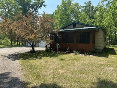 This well kept 2 bedroom is in a great location with paved road on Marquette Trails Country Club in Michigan - for sale on GolfHomes.com, golf home, golf lot