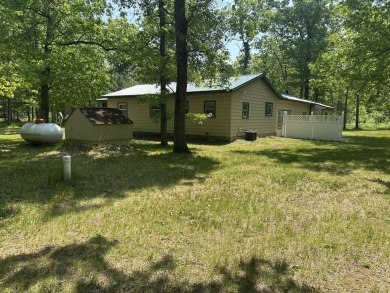This well kept 2 bedroom is in a great location with paved road on Marquette Trails Country Club in Michigan - for sale on GolfHomes.com, golf home, golf lot