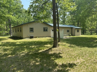 This well kept 2 bedroom is in a great location with paved road on Marquette Trails Country Club in Michigan - for sale on GolfHomes.com, golf home, golf lot