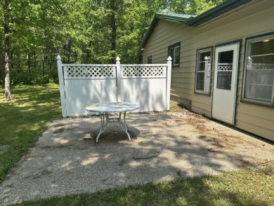 This well kept 2 bedroom is in a great location with paved road on Marquette Trails Country Club in Michigan - for sale on GolfHomes.com, golf home, golf lot