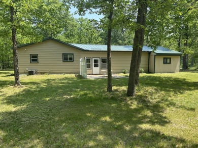 This well kept 2 bedroom is in a great location with paved road on Marquette Trails Country Club in Michigan - for sale on GolfHomes.com, golf home, golf lot