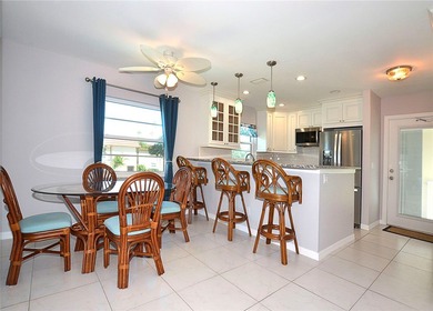 Remodeled end unit w/ serene golf/lake views, tons of natural on The American Golf Club in Florida - for sale on GolfHomes.com, golf home, golf lot