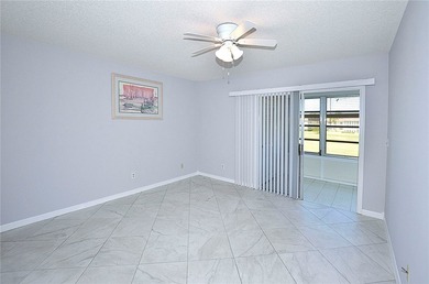 Remodeled end unit w/ serene golf/lake views, tons of natural on The American Golf Club in Florida - for sale on GolfHomes.com, golf home, golf lot