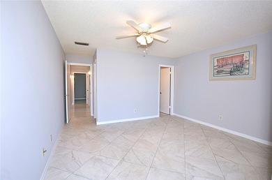 Remodeled end unit w/ serene golf/lake views, tons of natural on The American Golf Club in Florida - for sale on GolfHomes.com, golf home, golf lot