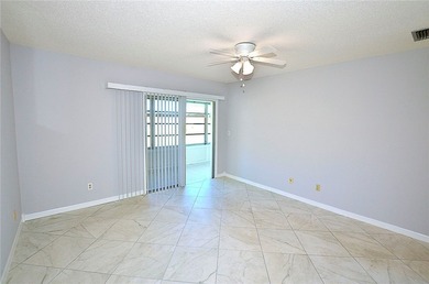 Remodeled end unit w/ serene golf/lake views, tons of natural on The American Golf Club in Florida - for sale on GolfHomes.com, golf home, golf lot