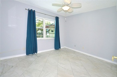 Remodeled end unit w/ serene golf/lake views, tons of natural on The American Golf Club in Florida - for sale on GolfHomes.com, golf home, golf lot