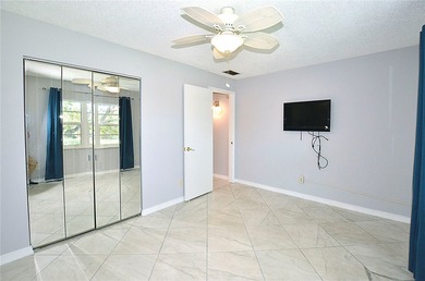 Remodeled end unit w/ serene golf/lake views, tons of natural on The American Golf Club in Florida - for sale on GolfHomes.com, golf home, golf lot