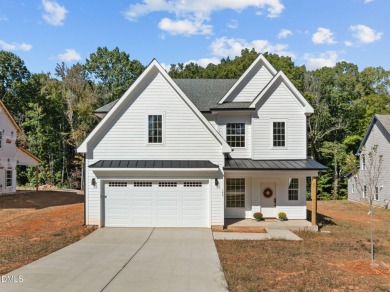 Welcome home to this spacious 4-bedroom, 2.5-bath residence on Olde Liberty Golf and Country Club in North Carolina - for sale on GolfHomes.com, golf home, golf lot