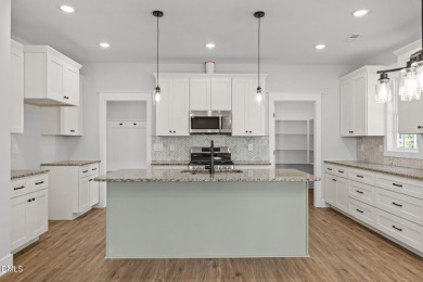 Welcome home to this spacious 4-bedroom, 2.5-bath residence on Olde Liberty Golf and Country Club in North Carolina - for sale on GolfHomes.com, golf home, golf lot