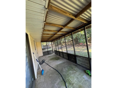 This 3 bedroom home is located in Diamondhead. Wood burning on Diamondhead Country Club in Mississippi - for sale on GolfHomes.com, golf home, golf lot